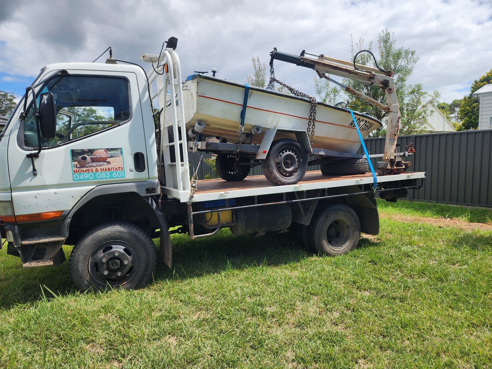 Crane truck lifting a cake cabinet
